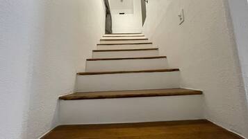 A staircase with wooden steps leading to a landing.