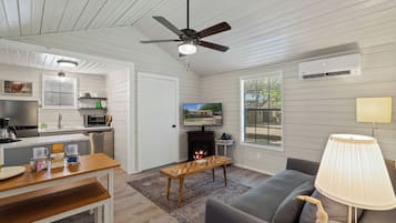 A modern living space with a kitchen, dining area, and seating area.