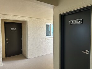 A hallway with two doors, one labeled '306' and the other 'Laundry'. - Toes-in-the-Sand - Oceanfront Views - New Smyrna Beach (New Smyrna Beach)