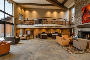A spacious lobby with a reception desk, seating area, and a fireplace. - Romantic Retreat - 4 Min to Skiing (Park City)