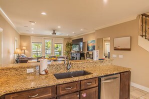 A kitchen with granite countertops, a stainless steel sink, and a dishwasher. - Waterfront Home with Pool-Dock-Waterviews-Near the Beach (Panama City Beach)