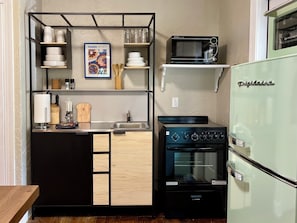A compact kitchen with a built-in oven, a microwave, and a refrigerator. - New Listing! Charming Cottage-Great Location! TMH-Midtown-Downtown-FSU (Tallahassee)