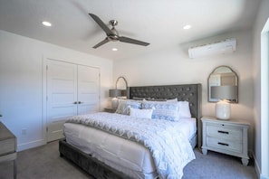 A bedroom with a bed, nightstands, a ceiling fan, and an air conditioning unit. - Spacious 5bedroom house in St. George w Access for 8 people to Las Palmas resort (St. George)