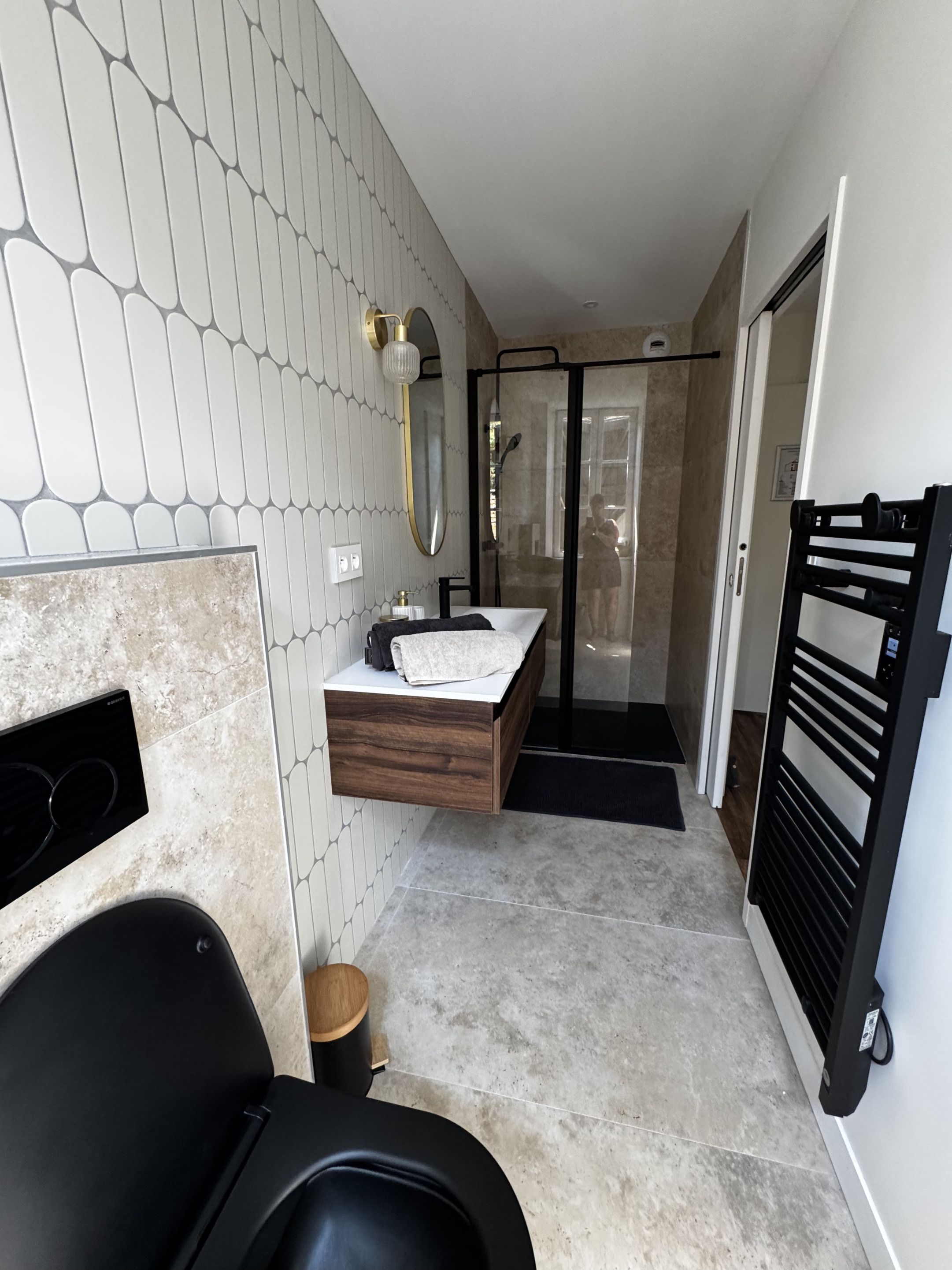 A modern bathroom with a built-in shower, a vanity with a mirror, and a toilet.