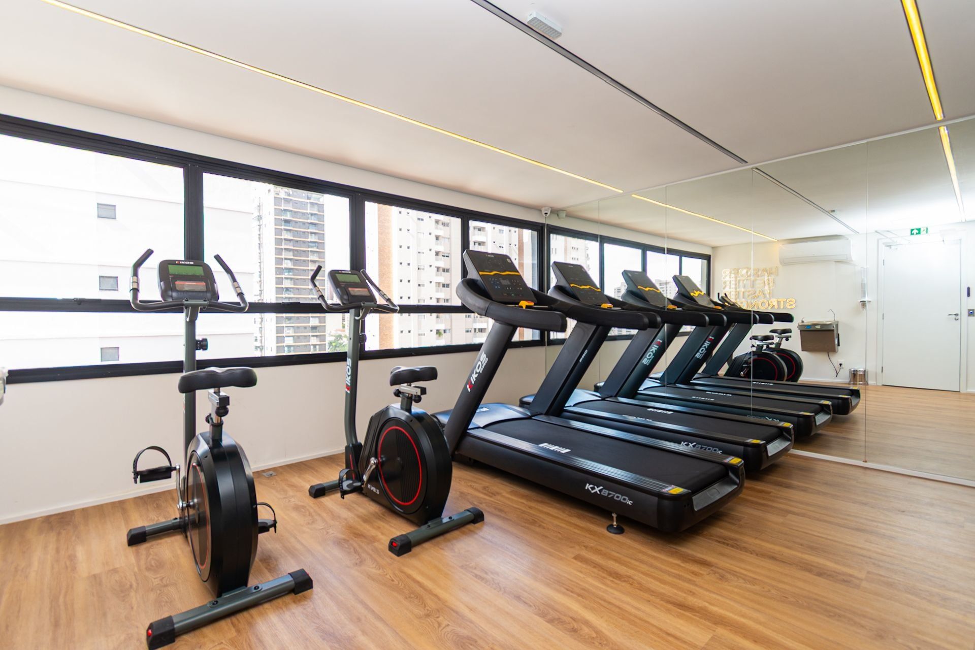 A gym with treadmills, an elliptical, and a stationary bike.