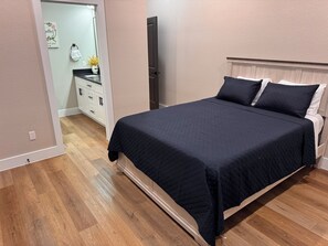A bedroom with a bed, a dresser, and a mirror. - New 3BR/2.5BA Near LBJ Hospital - Corporate & Extended Stays (Houston)