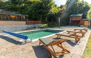 A swimming pool with lounge chairs and a blue water slide. - Gorgeous home in Plaski with private swimming pool, can be inside or outside (Plaski)