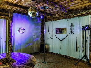 A room with a disco ball, a microphone stand, and a poster on the wall. - Hill-Billy Hilton Cabin near Mammoth Cave and Nolin Sleeps 16 (Clarkson)