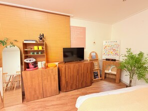 A modern bedroom with a wooden bed, a TV, a bookshelf, and a small desk. - Stay in Trendy Yongsan /Seoul /3-min walk to Subway & Airport Bus (Seoul)