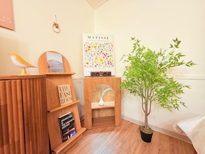 A room with a wooden desk, a bookshelf, a framed poster, a potted plant, and a bed. - Stay in Trendy Yongsan /Seoul /3-min walk to Subway & Airport Bus (Seoul)