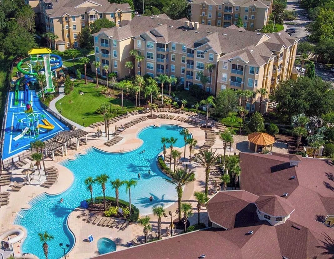 A resort with a large swimming pool, a water park, and multiple hotel buildings.