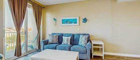 A living room with a sofa, a coffee table, and a small side table.