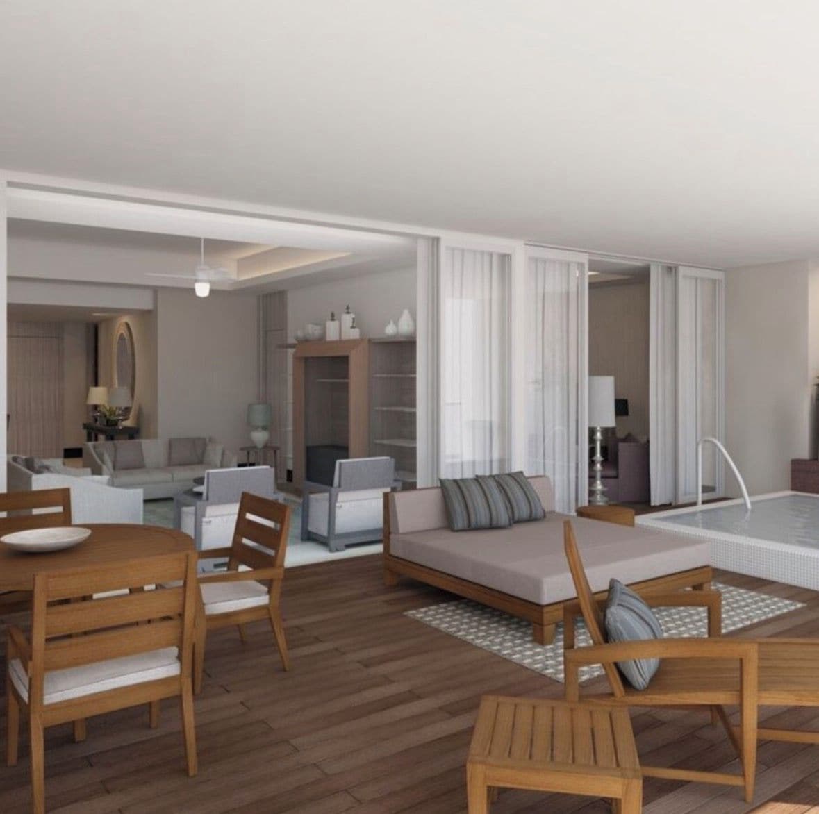 Une chambre d’hôtel moderne comprenant un coin repas, un canapé, une petite table et un espace piscine.