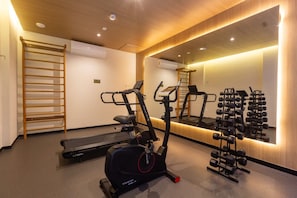 A gym with exercise equipment including treadmills, an elliptical, and a weight rack. - Studio w/ Terrace in Condo. w/ Coworking Tpa0112 (São Paulo)