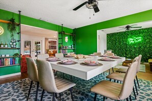 A modern dining area with a white table set for six, surrounded by beige chairs. - 4 Min to Beach! 85°F Pool•Sauna•Golf•Pickleball (Seminole)