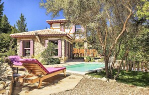 A villa with a swimming pool, outdoor seating, and a garden. - Amazing home in Lefkada with private swimming pool, can be inside or outside (Lefkada)