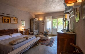 A bedroom with a large bed, a wooden dresser, a chair, and a desk with a lamp. - Stunning home in Serra San Quirico with outdoor swimming pool (Serra San Quirico)