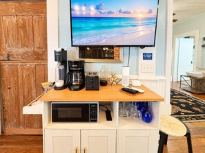 A kitchen area with a coffee maker, toaster, and microwave. - Downtown Secluded Cottage #4 (Pensacola)