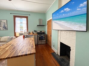 A kitchen with a wooden countertop, a stove, and a fireplace. - Downtown Escape #2- New Listing! (Pensacola)