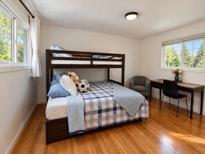 A bedroom with a bunk bed, a desk, and a chair. - The Mercer Haven  (Mercer Island)