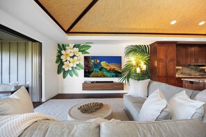 A modern living room with a sofa, coffee table, and artwork on the wall. - Luxury Villa Designer updates HI Gem Kings (Waimea)