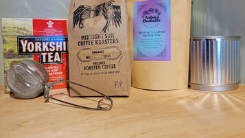 A coffee roaster, a Yorkshire Tea bag, a bag of Midnight Sun Coffee Roasters, and a canister.