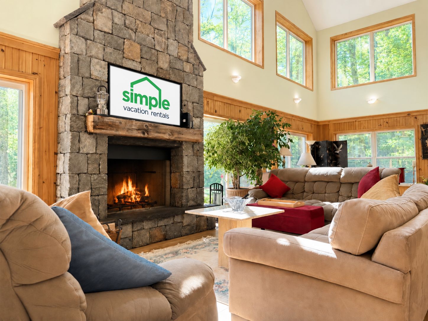 A cozy living room with a stone fireplace, a large window, and a comfortable seating area.