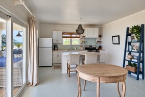 Fully equipped kitchen and dining with sea views. - Bohemia Cosmo - A Beachfront Bungalow, Pool & Daybed (Governor's Harbour)
