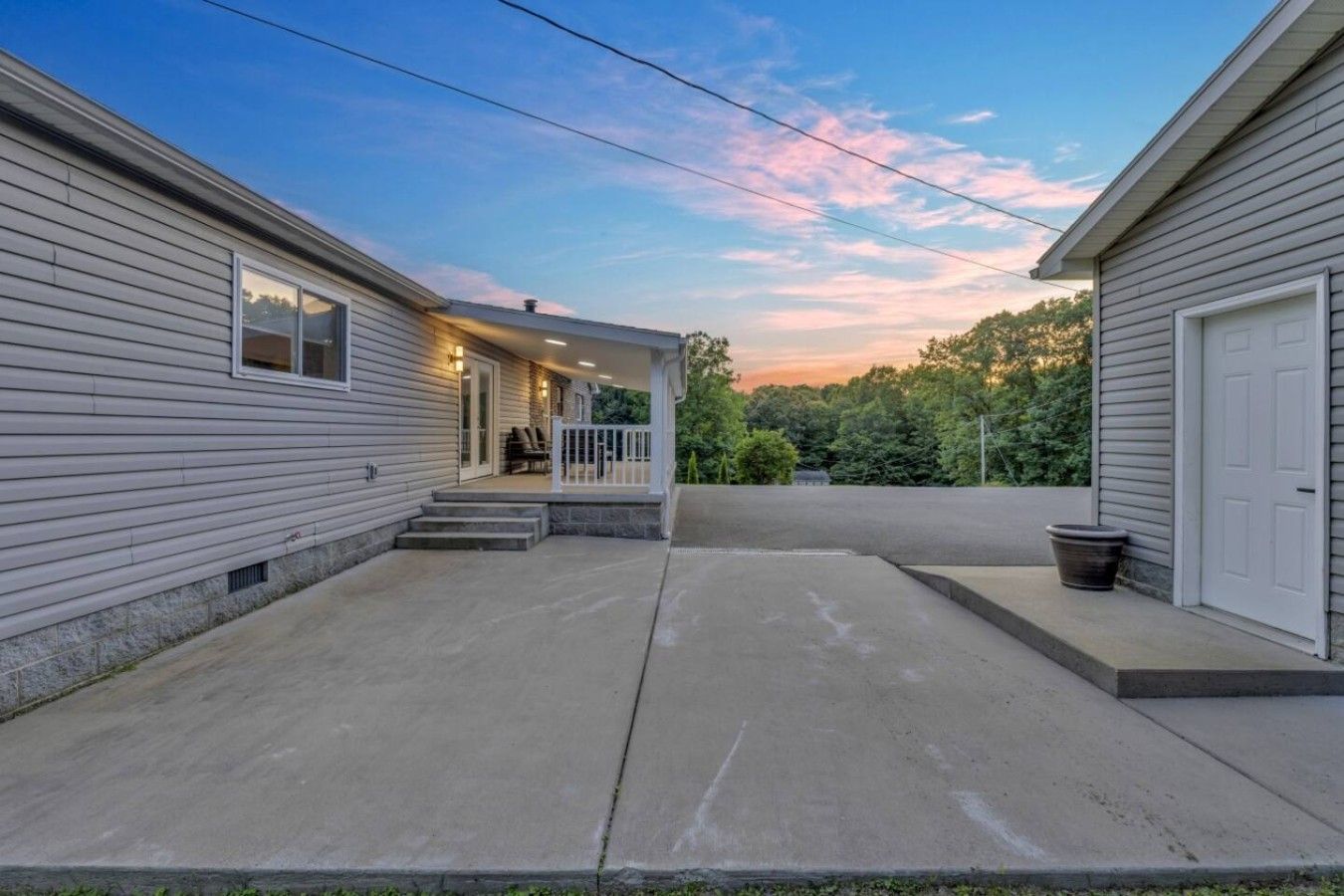 A residential property with a covered patio, a front door, and a garage.