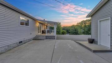 A residential property with a covered patio, a front door, and a garage.