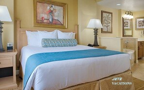 A hotel room with a large bed, two bedside tables with lamps, a dresser, and artwork on the walls. - 1BR DELUXE sleeps 4- Holiday Get Away 5min to Disney-Wyndham Bonnet Creek Resort (Lake Buena Vista)