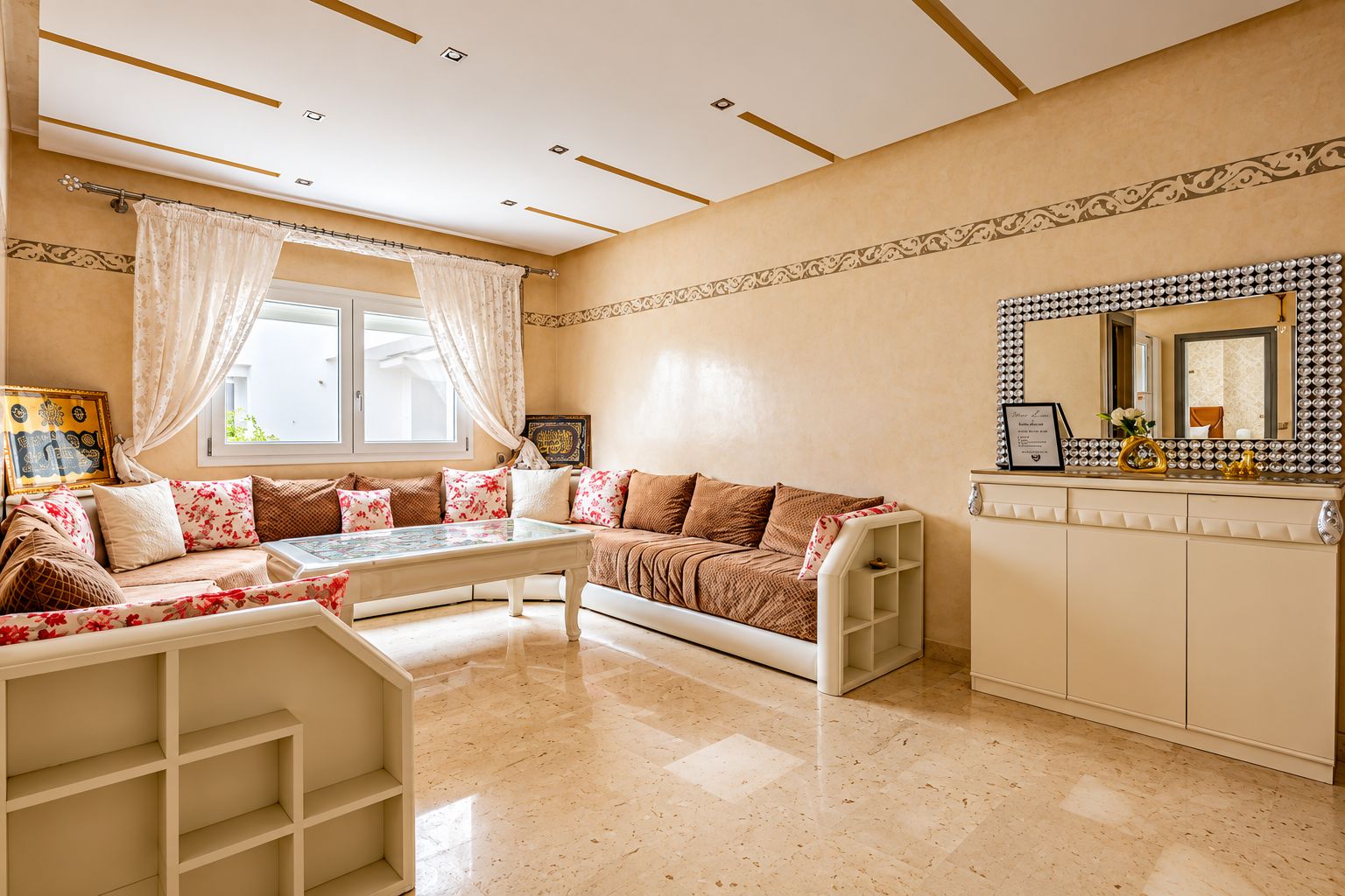 A room with a sofa set, a coffee table, a decorative mirror, and a cabinet.