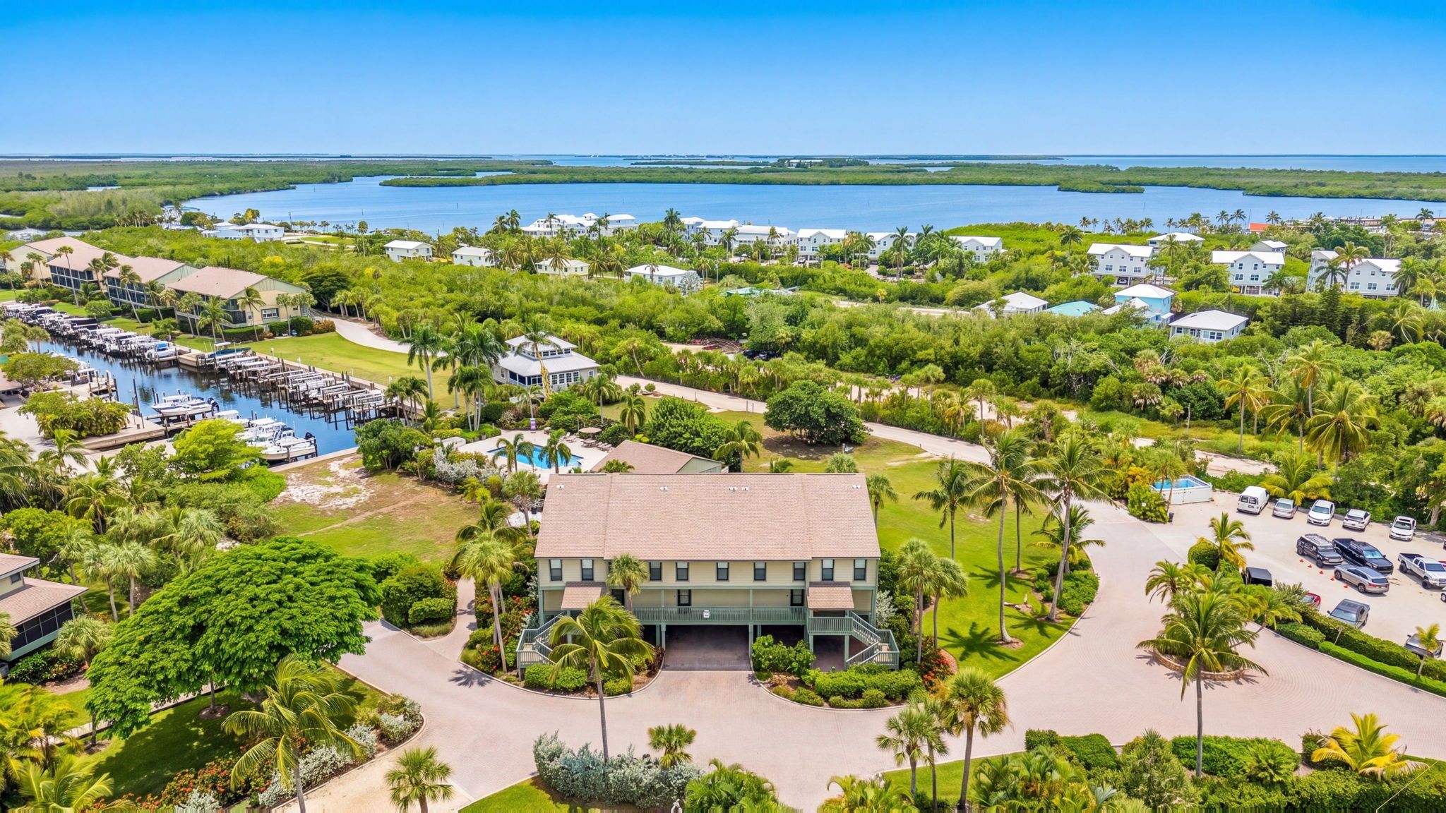 A resort with a marina, swimming pool, and lush greenery.