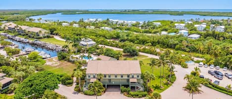 A resort with a marina, swimming pool, and lush greenery.