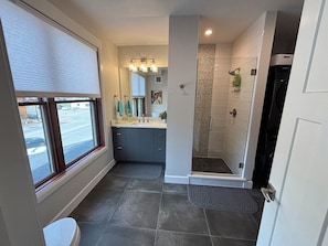 A modern bathroom with a shower, toilet, and sink. - Ski Winter Park! Cozy Grand Lake Condo ~40 Min to the Slopes (Grand Lake)