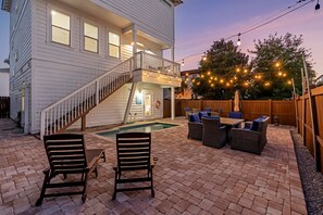 A two-story house with a backyard patio, a swimming pool, and outdoor lighting. - Coastal Paradise - Miramar Beach Escape with Pool & Golf Cart (Miramar Beach)