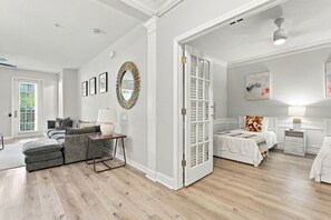 A spacious living room with a grey sofa, a coffee table, and a fireplace. - Spacious 3BR in Prime Orlando Location (Orlando)