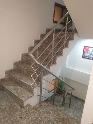 A staircase with metal railings and granite steps. - Hotel silver stay delhi  (New Delhi)