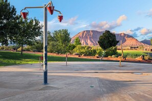 A park with a concrete path, a street lamp, and a mountain in the background. - Red Rock Adventure Oasis with a Private Hot Tub, game room, and Fire Pit! (Santa Clara)