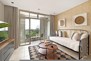 A modern bedroom with a sofa, a round wooden table, and a view of greenery through large sliding doors. - Secure One Bed Apartment Modern and Spacious (Cape Town)