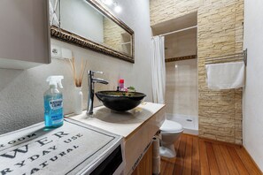 A bathroom with a modern sink, a toilet, and a shower area. - Plac Solidarności Spacious Apartment (Gdańsk)