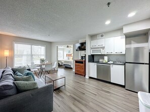 A modern apartment with a living room, dining area, and kitchen. - Ground-floor Disney condo with resort pool (Kissimmee)
