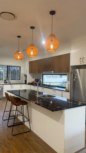 A modern kitchen with a central island, stainless steel appliances, and pendant lighting. - Relax recharge ! (Clontarf)