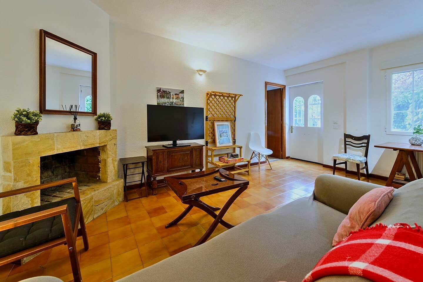 A living room with a fireplace, television, and seating area.