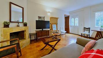 A living room with a fireplace, television, and seating area.