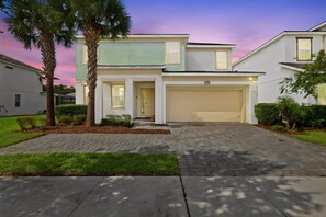 A two-story residential house with a garage, a driveway, and a well-maintained lawn. - Best location near Orlando’s world famous attractions (Kissimmee)