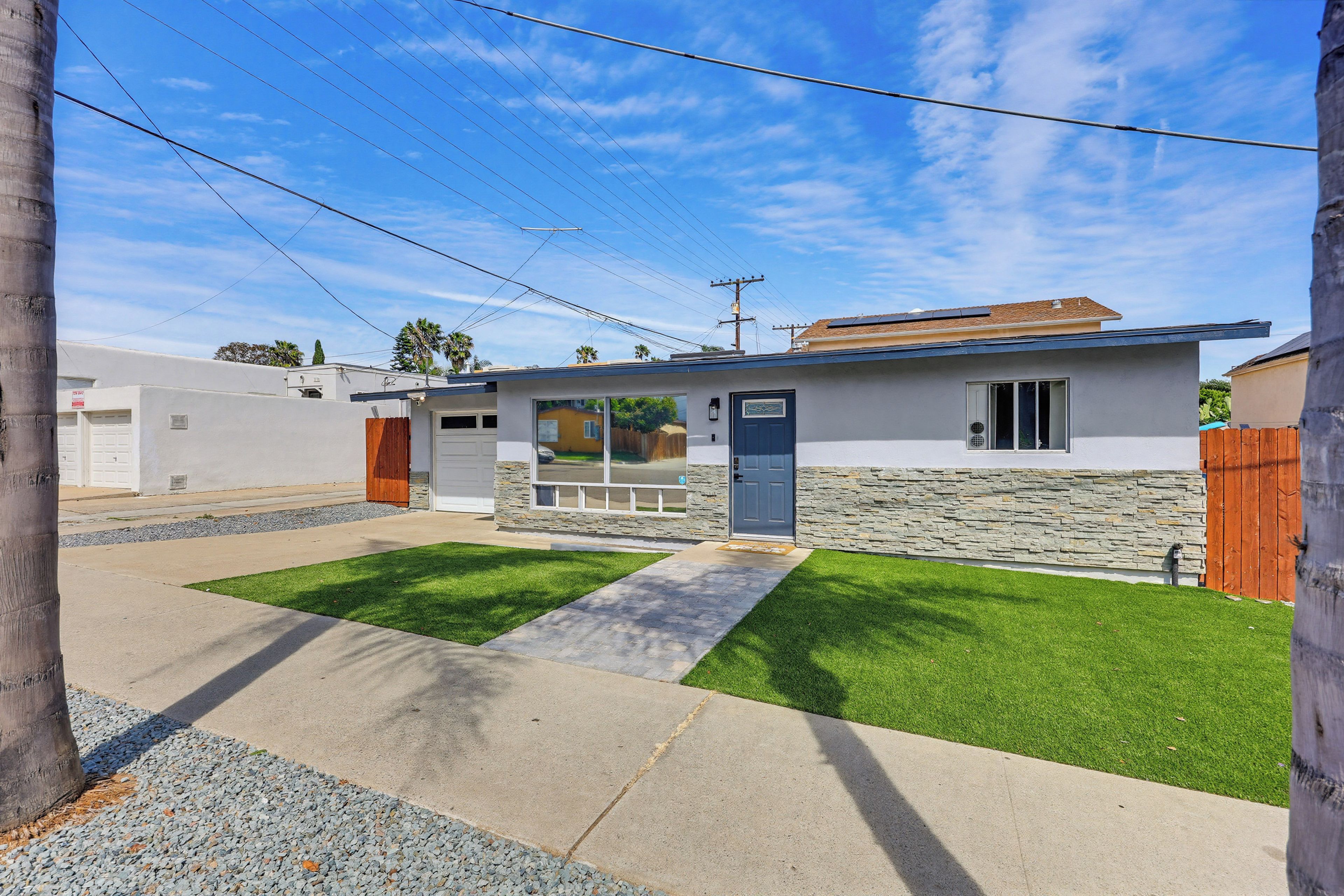 A residential property with a stone facade, a front door, and a small porch.