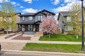 A residential area with houses featuring front porches, a well-maintained lawn, and a clear sky. - A Cozy Gem in The Greens.
Welcome to your cozy home away from home in TheGreens! (Regina)