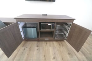 A kitchen area with a microwave, a trash bin, and a built-in oven. - Mustang Queen Bedroom in the Heart of SLO (San Luis Obispo)