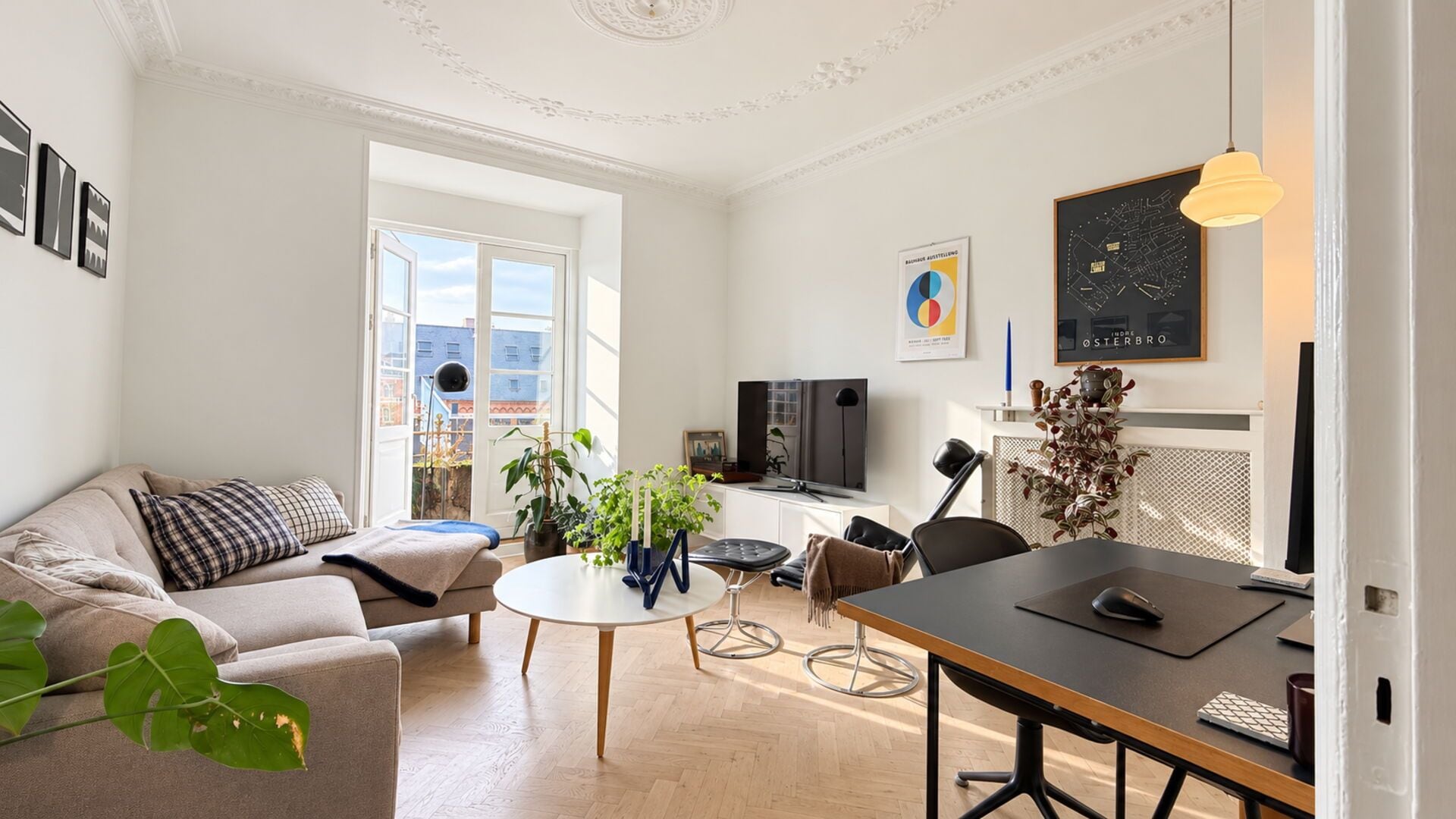 A modern living room with a sofa, coffee table, and dining area.